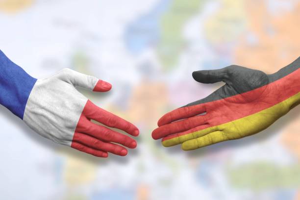 istock France and Germany - Flag handshake symbolizing partnership and cooperation 1299511644