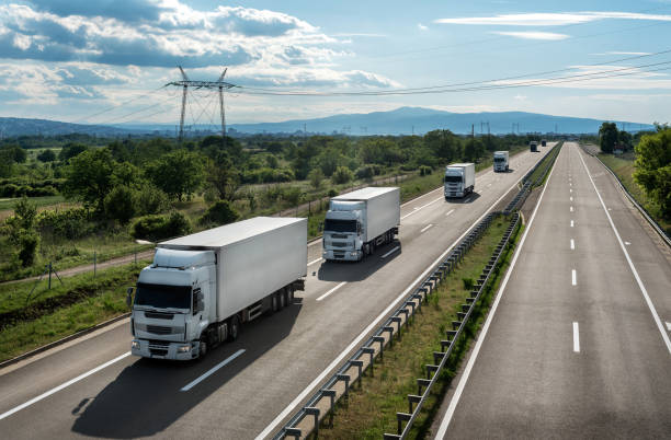 istock Transportation trucks passing by on asphalt highway 1299512690