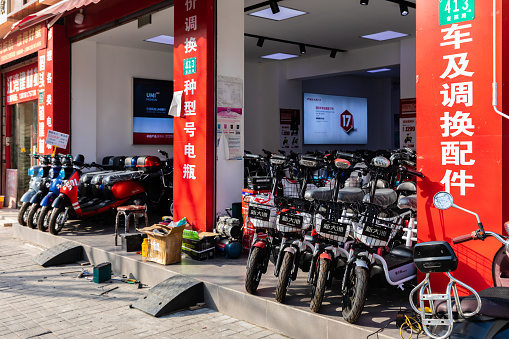 Shanghai, China - January 30, 2021: An electric scooter shop on Kuizhao Road near Jiangwanzhen, Hongkou District, Shanghai. Battery powered. Environment friendly. Green.
