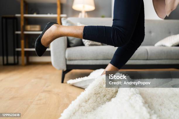 Falldown Hazard Clumsy Woman Stumbled Stock Photo - Download Image Now - Falling, Tripping - Falling, Rug