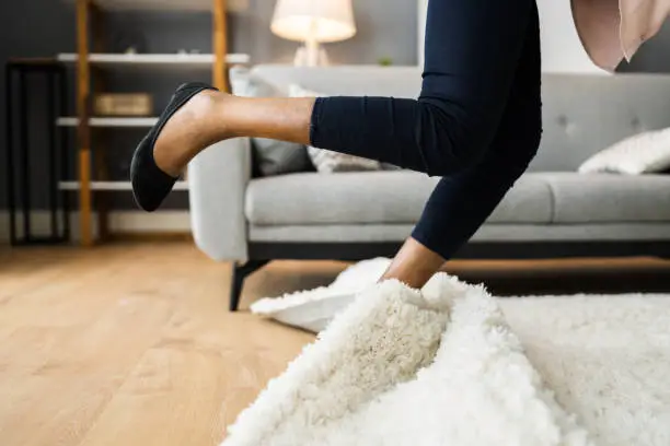 Falldown Hazard. Clumsy Woman Stumbled On Rug