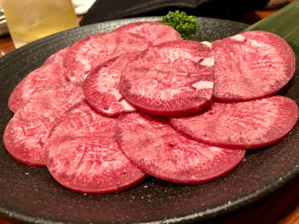 istock Beef tongue on the black plate. 1299527966