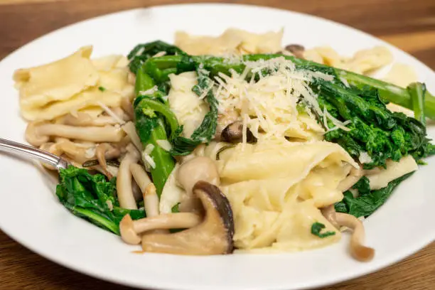 Homemade Pappardelle pasta cooked with Broccoli Rabe and Mushrooms