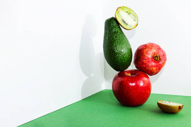 istock A stack of fruit, apple, avocado, pomegranate and kiwi. 1299531311