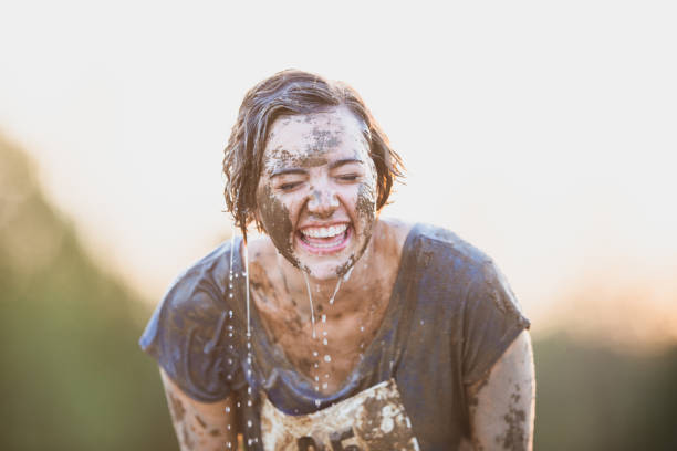 istock Beautiful young women in a mudrun competition 1299532119