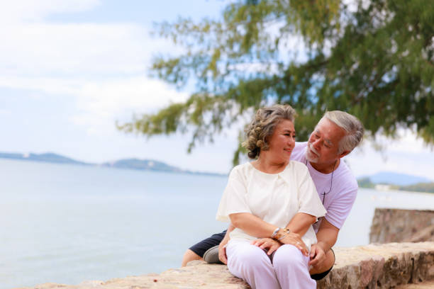 istock Asian senior couple on the beach 1299532222