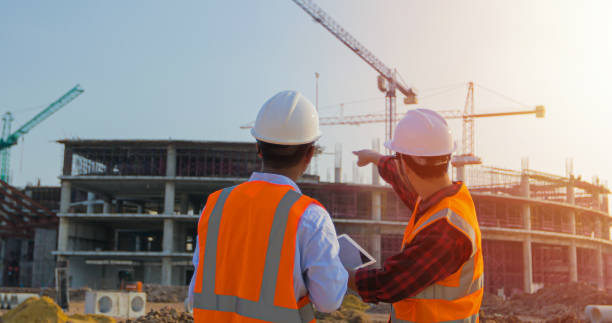 Two asian engineering using the tablet for discussion and working at construction on site Two asian engineering using the tablet for discussion and working at construction on site construction site stock pictures, royalty-free photos & images