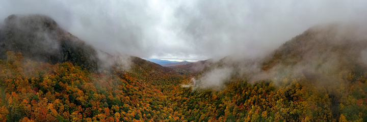 Panoramic view of peak fall foliage in Smugglers Notch, Vermont.