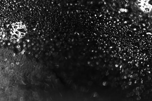 istock Water drops in the black bokeh background while outside is lights are shining 1299538499