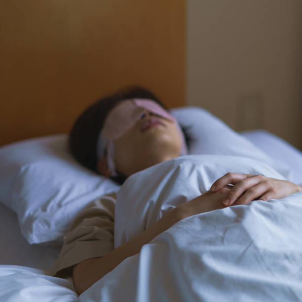 istock middle aged woman sleeping in the bed 1299543255