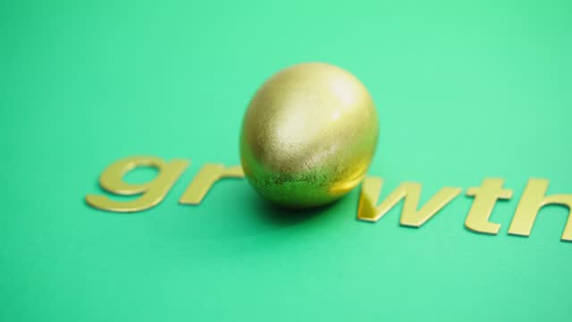single word growth with an golden egg as alphabet O on the green background