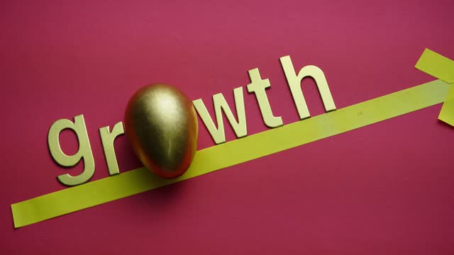 single word growth and golden egg on the red background
