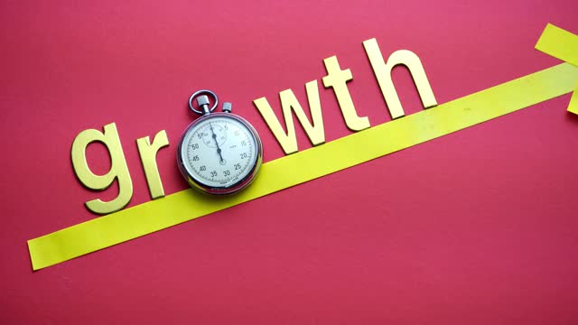 single word growth with stopwatch on the red background