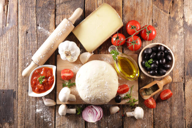 istock pizza dough with ingredient on wooden board 1299546040