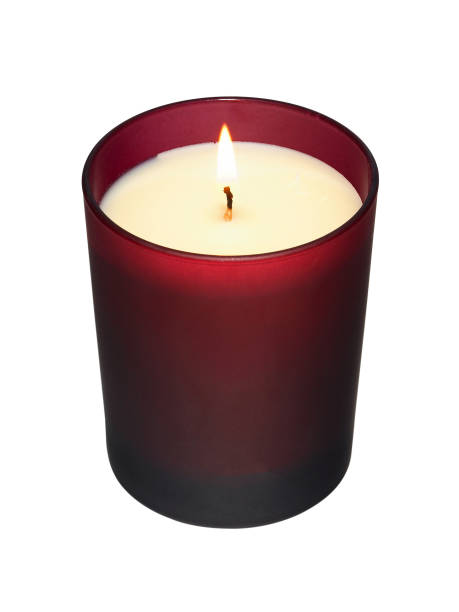 istock White burning candle in red glass on white background 1299547741