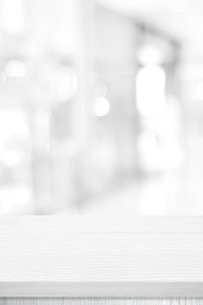 istock Vertical white table presentation, desk and blur background, Empty wood counter, shelf surface over blur restaurant white bokeh background, Wood table top for retail shop, store product display banner, mock up 1299549169