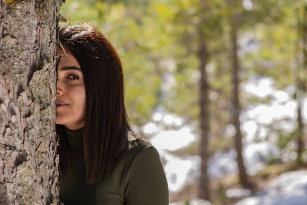 istock The woman in the forest and love with pine tree. 1299551376