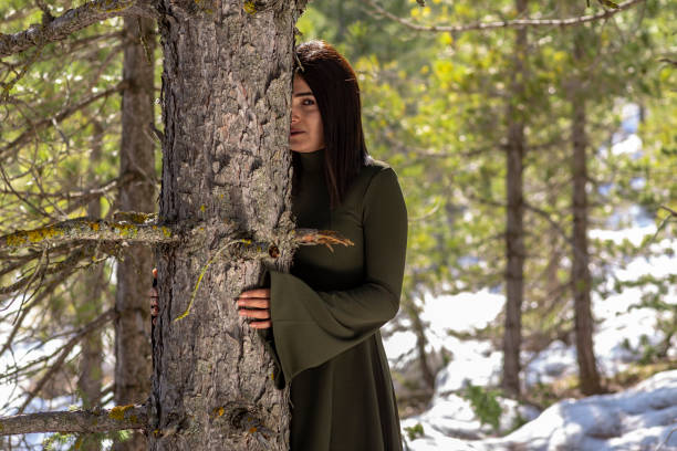 istock The woman in the forest and love with pine tree. 1299551399