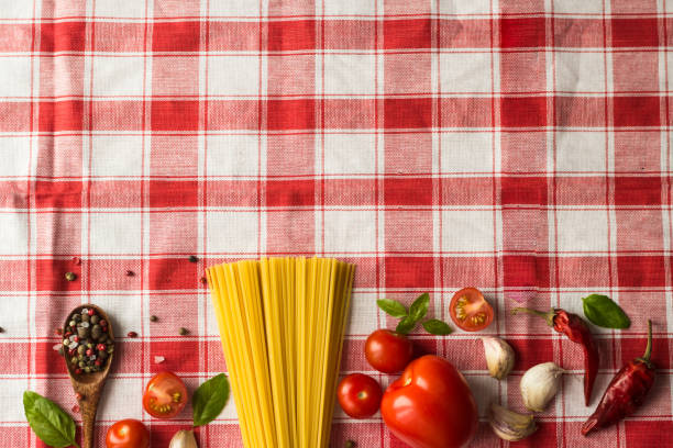 istock Marinara pasta ingredients lie on a checkered tablecloth. raw tagliatelle with spices and small cherry tomatoes 1299551510