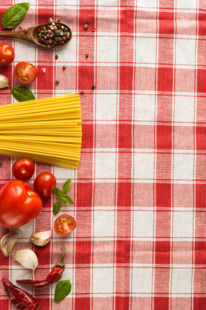 istock Marinara pasta ingredients lie on a checkered tablecloth. raw tagliatelle with spices and small cherry tomatoes 1299551534