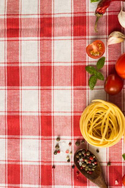 istock Marinara pasta ingredients lie on a checkered tablecloth. raw tagliatelle with spices and small cherry tomatoes 1299551567
