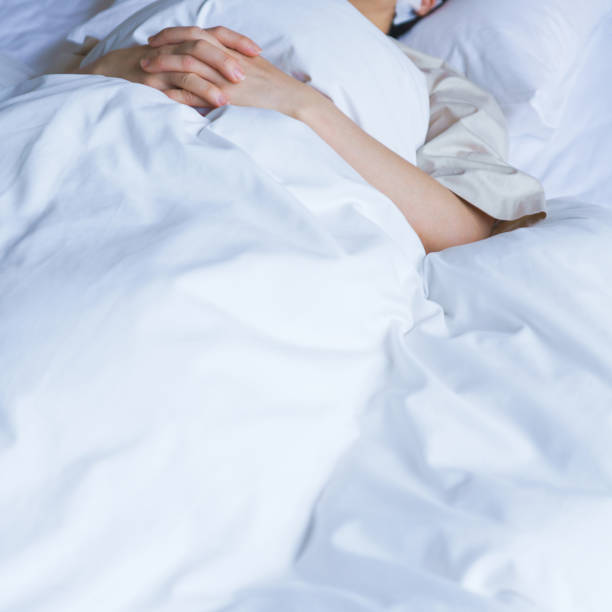 istock middle aged woman sleeping in the bed 1299551828