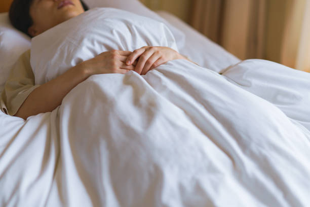 istock middle aged woman sleeping in the bed 1299551832
