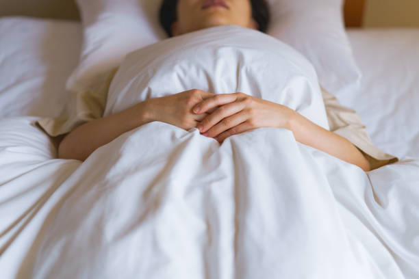 istock middle aged woman sleeping in the bed 1299551852
