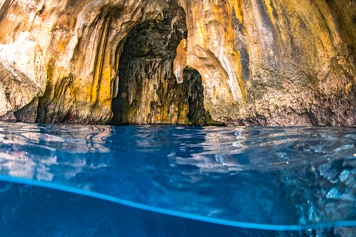 Sea cave above and below with aquamarine blue water