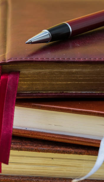 istock ballpoint pen lies on a notebook close-up 1299552649