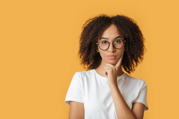 istock Human face expressions, emotions serious confident. Nice lady in glasses touch chin, look at camera 1299554509