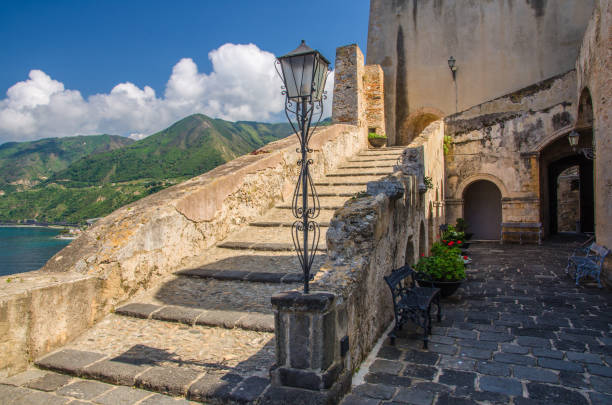 Courtyard old medieval castle Castello Ruffo, Scilla, Italy Scilla, Italy, May 10, 2018: Courtyard old medieval knight's castle on rock Castello Ruffo with stone ancient walls, street lamps, vases castle scilla stock pictures, royalty-free photos & images