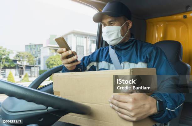 Delivery Man Wif A Parcel Box Stock Photo - Download Image Now - Truck Driver, Delivering, Driving