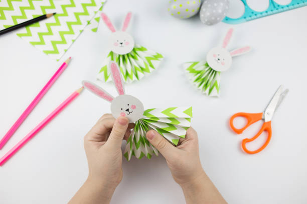 Easter bunny out of paper. DIY step by step. Crafts concept for kids.