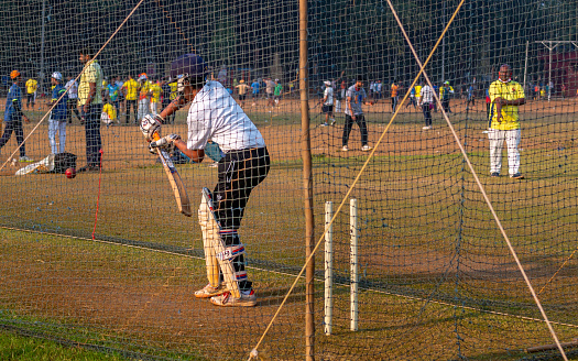 Mumbai, India - December 20, 2020: Unidentified boy practicing batting to improve cricketing skills at Mumbai ground