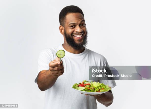 Cheerful Black Man Holding Salad Standing On White Background Studio Stock Photo - Download Image Now