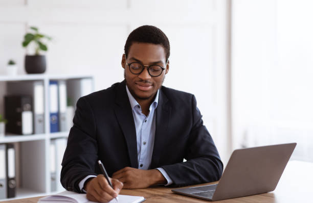 istock Enthusiastic black businessman planning his day in office 1299556896