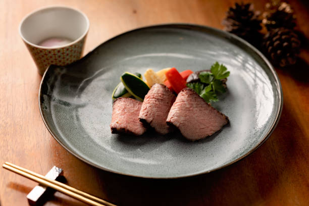 istock Fresh plate with roast beef served on a grey plate with vegetables 1299557122