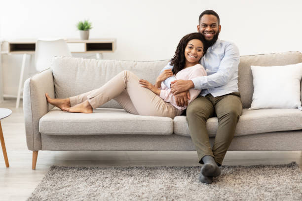 istock African american couple spending weekend together lying on sofa 1299557143