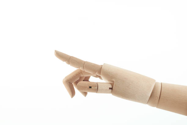 istock Wooden hand pointing finger 1299557390