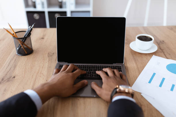 istock African american businessman hands typing on laptop with blank screen 1299558244