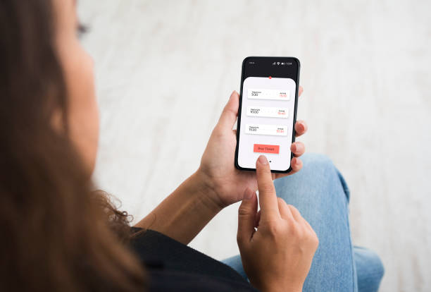 istock Unrecognizable Lady Buying Tickets Using Smartphone Application Sitting Indoors 1299560263