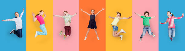 istock Carefree Children Jumping Posing Together On Colorful Studio Backgrounds, Collage 1299560389
