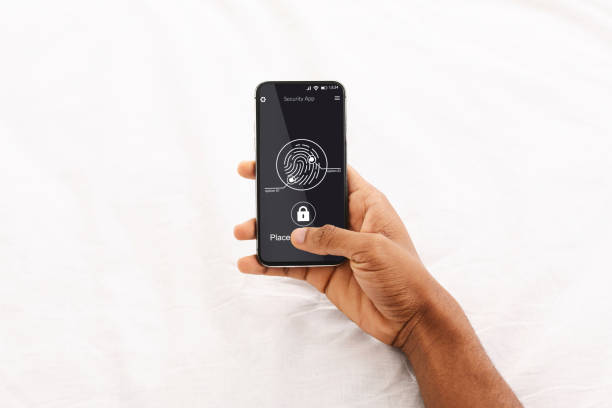 istock Unrecognizable Black Man Scanning Fingerprint On Phone Over White Background 1299560480