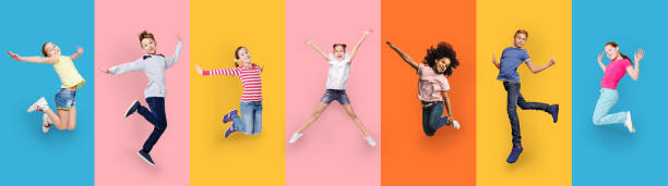 istock Happy Multiracial Children Jumping On Different Colored Backgrounds, Collage, Panorama 1299561281