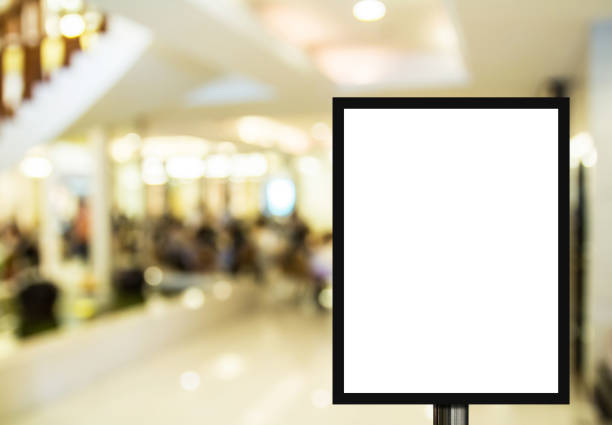 istock Blank advertising billboard or wide screen television with blurred shopping mall background 1299561929