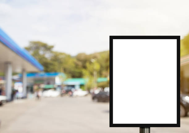 Blank advertising billboard or wide screen television with blurred gas station background, commercial and marketing concept, copy space for text or media content.