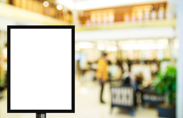 istock Blank advertising billboard or wide screen television with blurred shopping mall background 1299562011