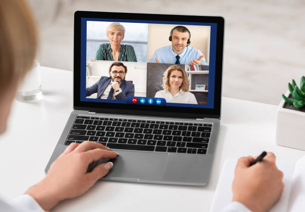 istock Lady Talking With Colleagues Online Via Video Call Sitting Indoors 1299562092