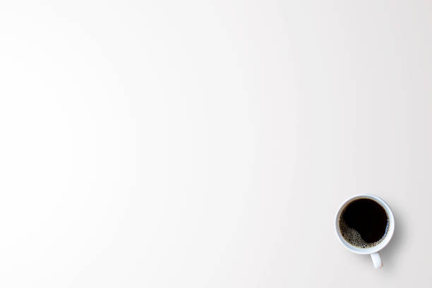 istock Cup of coffee on white background or office desk with workplace for use 1299562139